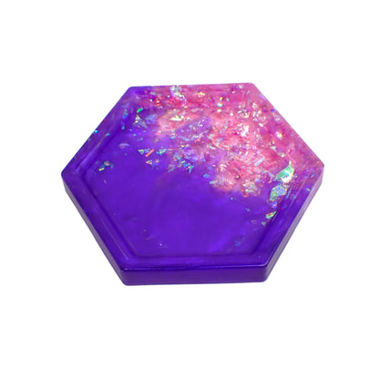 Geometric octagon handmade resin trinket dish with iridescent flakes. It has an area of pearly purple resin and an area of iridescent flakes that appear a light lilac purple to pink color.