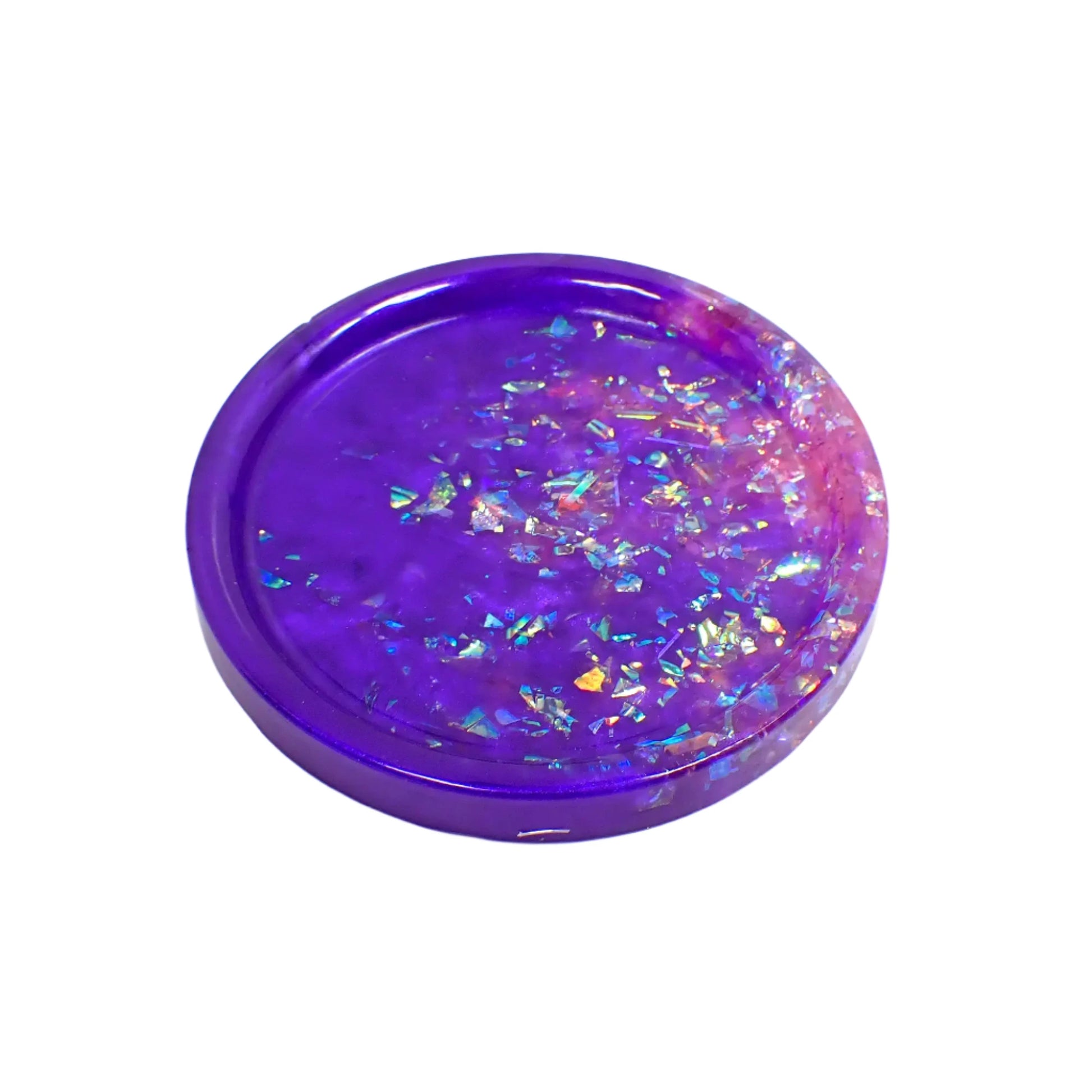 Handmade round resin trinket dish with iridescent flakes. It has an area of pearly purple resin and an area of iridescent flakes that appear a light lilac purple to pink color.