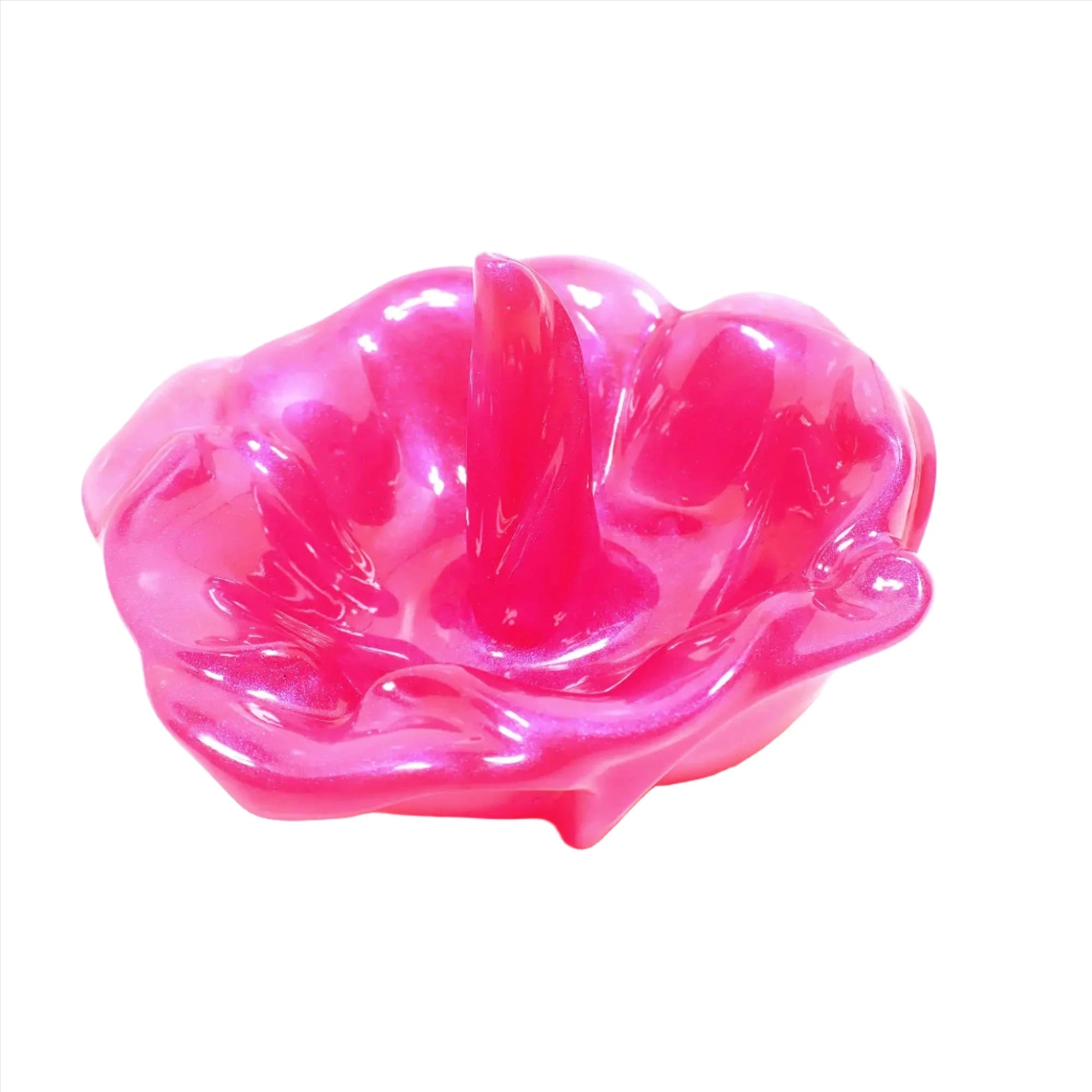 Angled view of the handmade resin ring dish holder. It is pearly bright hot pink in color with hints of purple sheen as the light hits it.