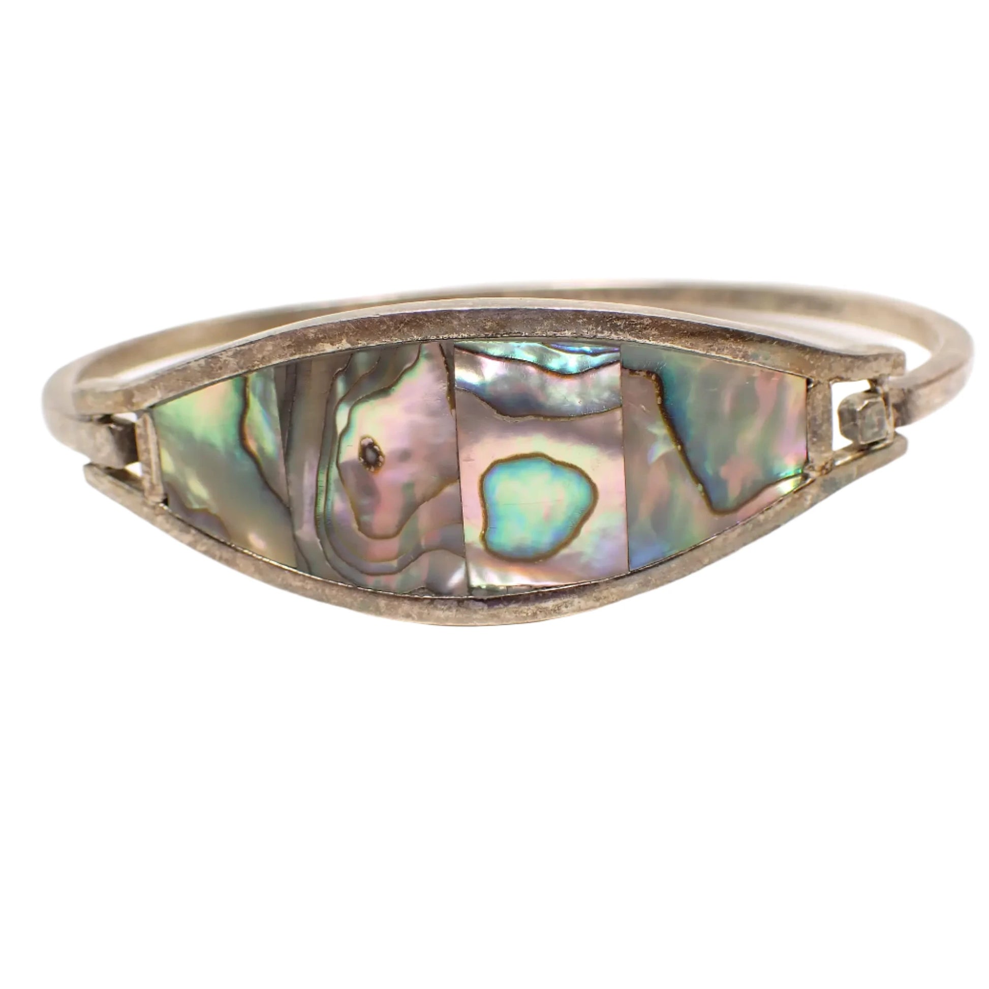 Enlarged front view of the vintage Alpaca hinged bangle bracelet. Here the four pieces of inlaid shell can be seen with flashes of different colors.