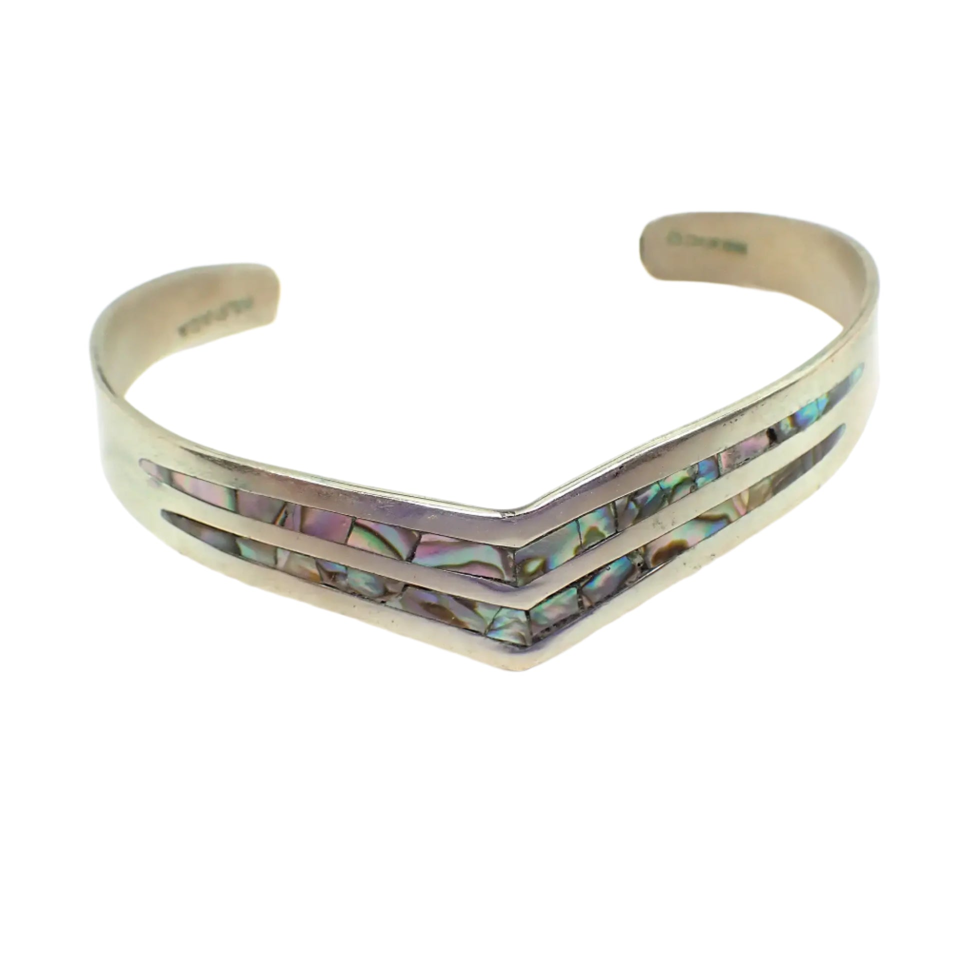 Front view of the vintage Alpaca Mexico vintage V cuff bracelet. It is silver tone in color with an angled V shape in the front and two rows of inlaid abalone shell.