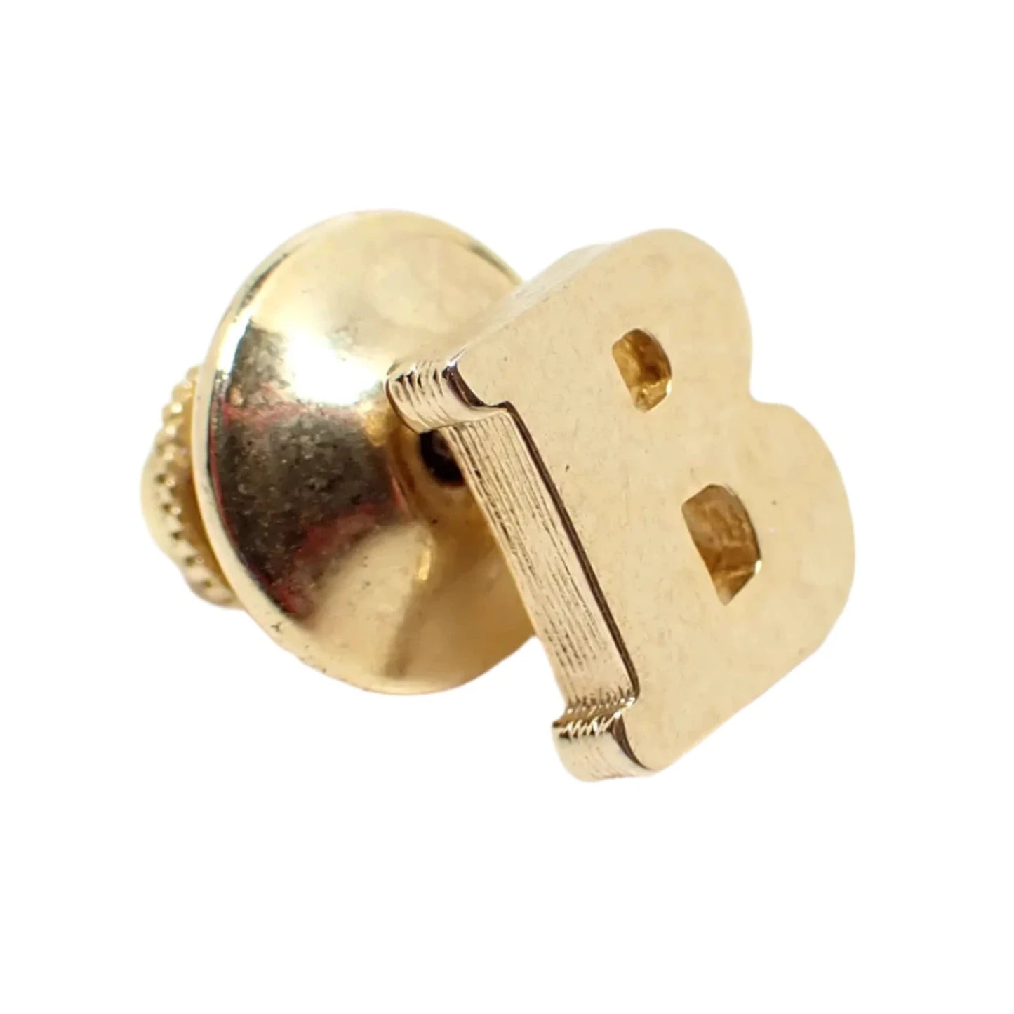 Enlarged view of the vintage initial letter B tie tack. The metal is gold tone in color. It has a cut out block letter style design. The clutch on the back is round without a chain.