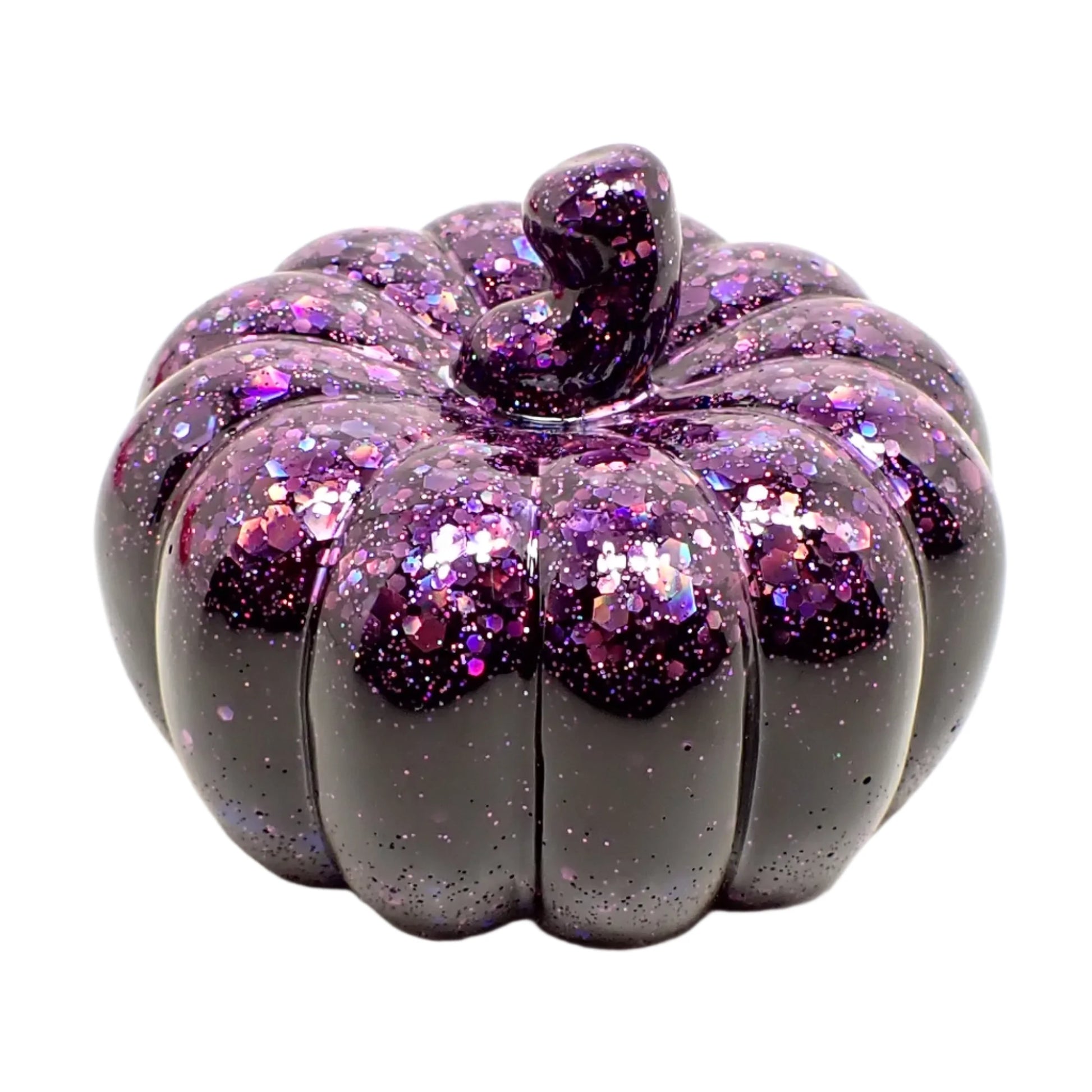 Angled view of the small black pumpkin decoration. It has black resin with chunky iridescent purple glitter on the top and stem of the pumpkin.