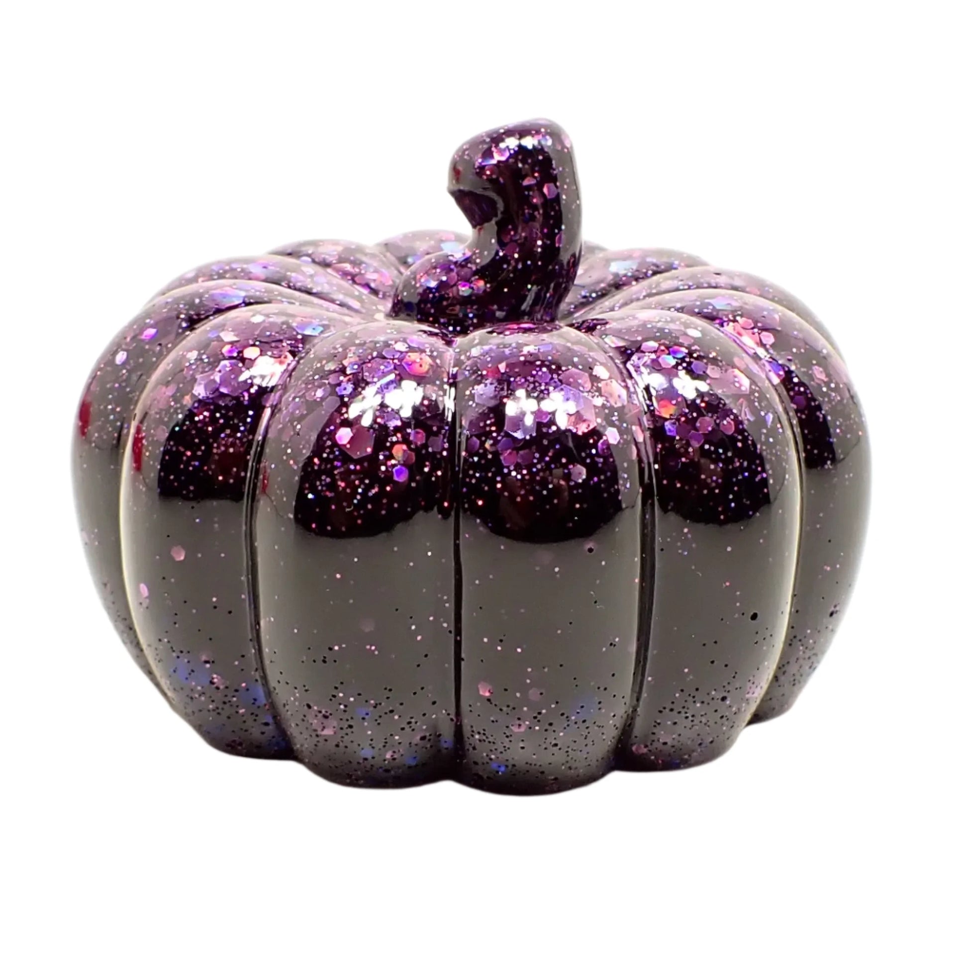 Side view of the pumpkin. The purple iridescent glitter is mainly on the top and stem portion of the pumpkin, but some intermittent flakes of glitter can also be seen in other areas of the pumpkin as well.