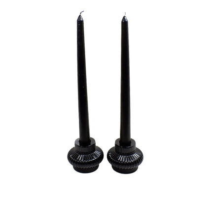 Photo of the candle holders holding black candlesticks.