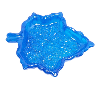 Top view of the blue leaf trinket dish so that more of the crystal like facets can be seen on the inside bottom area of the dish.