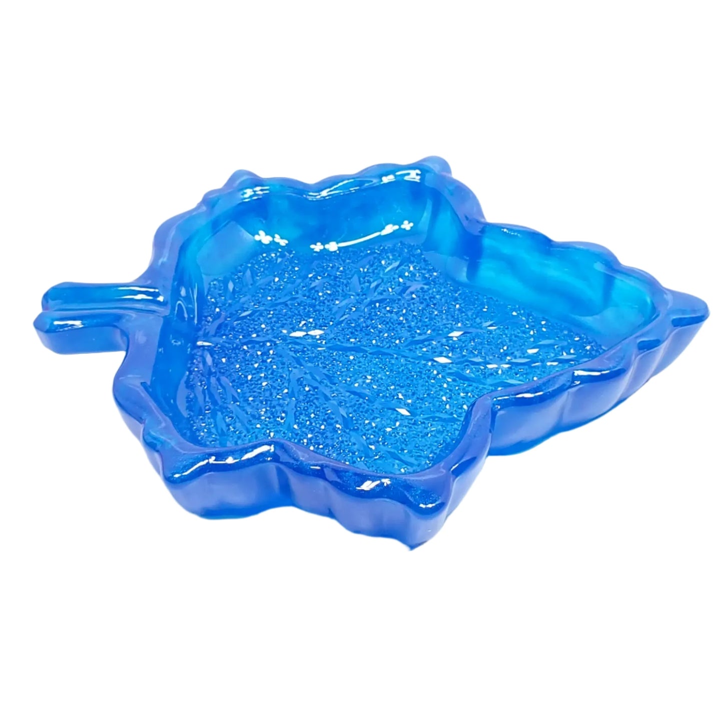 Side view of the blue leaf trinket dish showing the thickness of the outside edge. The pearly blue resin can also be seen better from this angle.