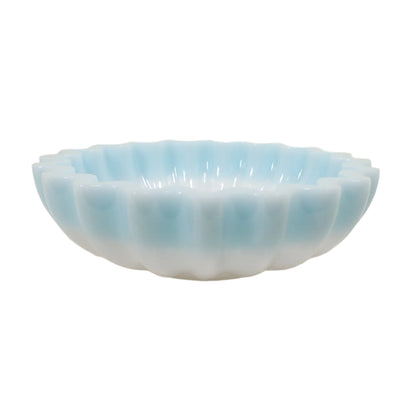 Side view of the handmade pastel blue and white resin bowl. The scalloped design goes around the whole outside of the bowl.