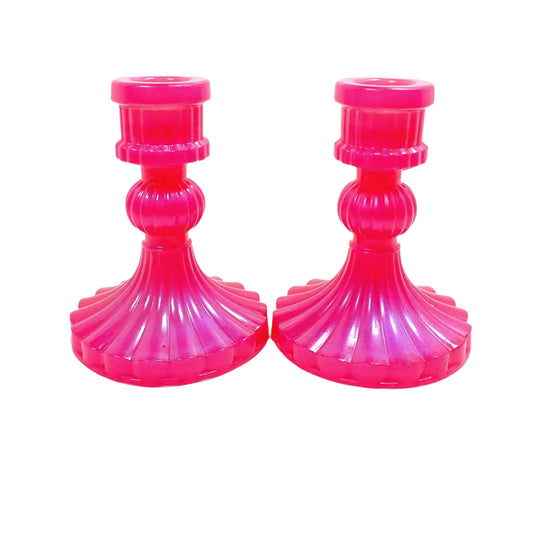 Side view of the handmade resin candle holders. The resin is a bright pearly pink in color. 