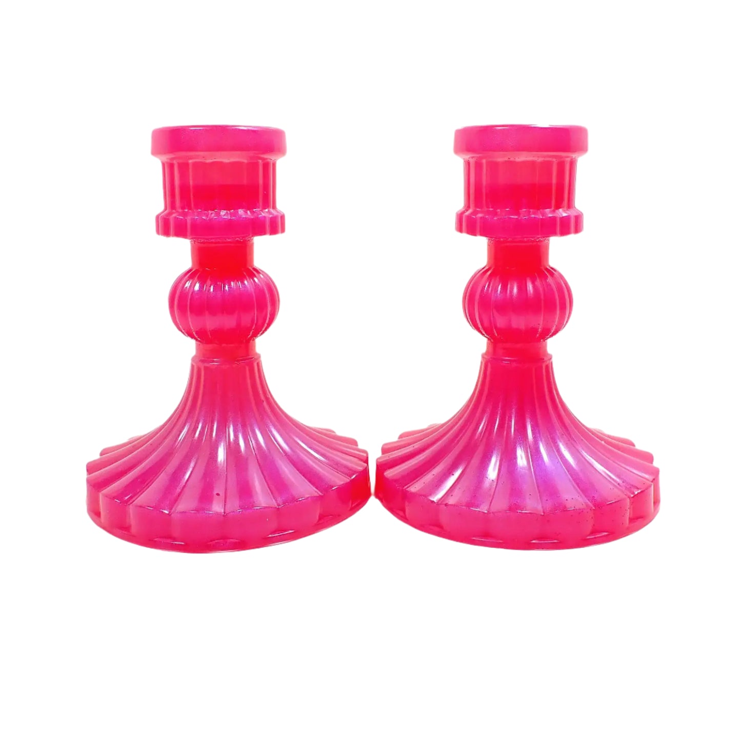 Another side view of the bright pink resin candle holders. They are a vintage style with corrugated design and flared round base.