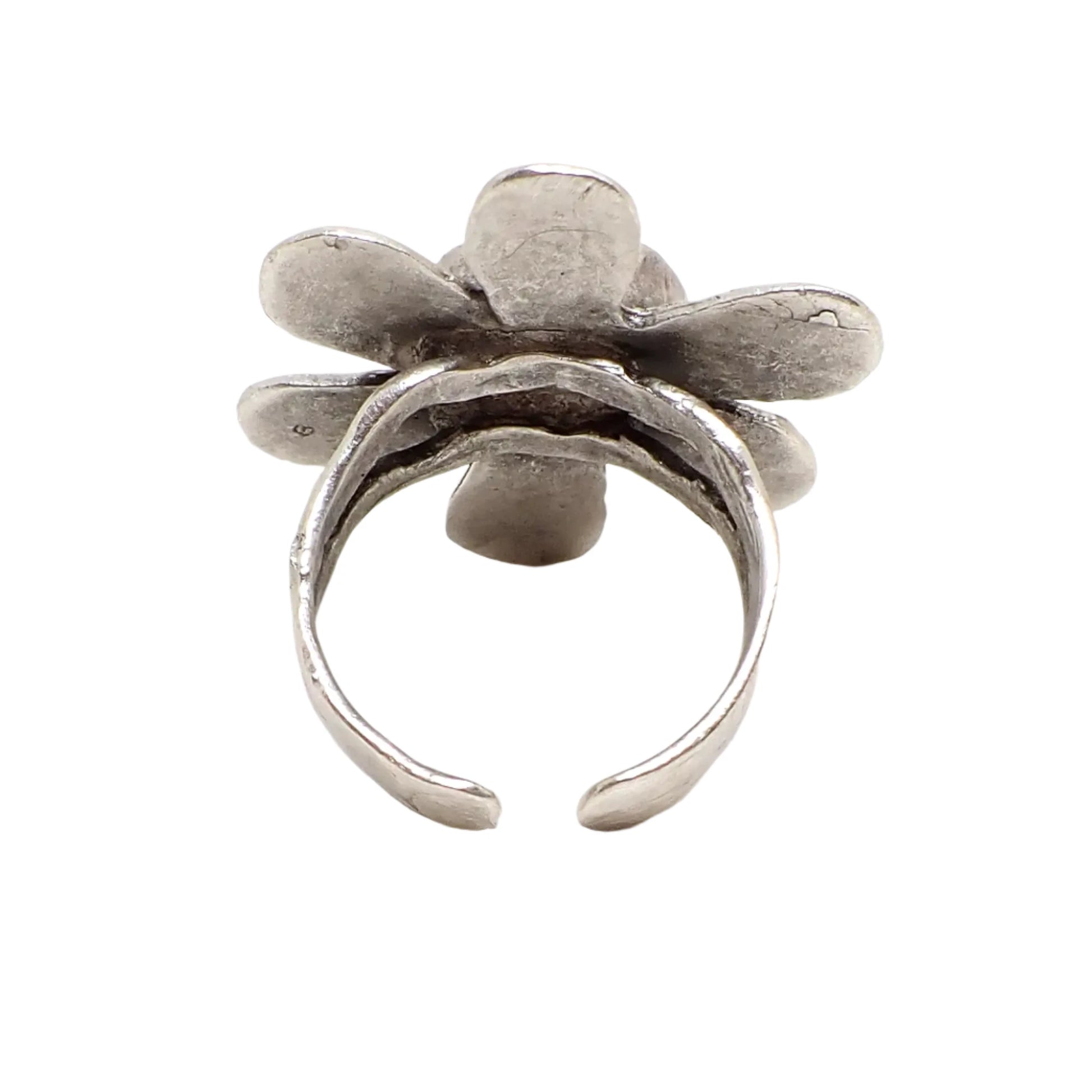 Photo of the back of the color shift flower ring showing the band. It is a split style band at the top with curved tapered ends. Between the ends is the opening where the size of the ring can be adjusted.