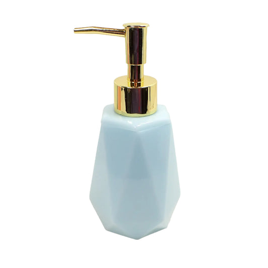 Angled view of the handmade resin soap dispenser. It has a faceted hexagon shape with faceted sides and a flared out bottom. The resin is pastel cotton candy blue in color.