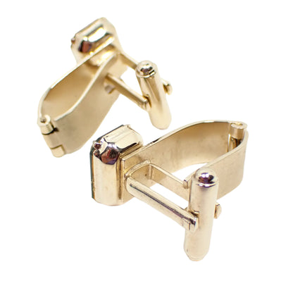 Photo showing the backs of the Dante green rhinestone cufflinks. The curved metal bars with hinge at the bottom can be seen. 