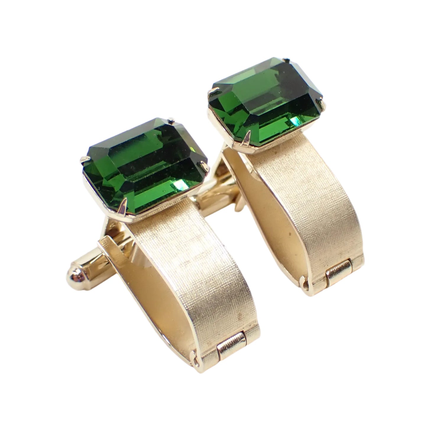 Angled view of the Dante wrap around cufflinks. The facets on the octagon green rhinestones can be seen as well as the hinge at the bottom of the curved metal pieces that wrap around.