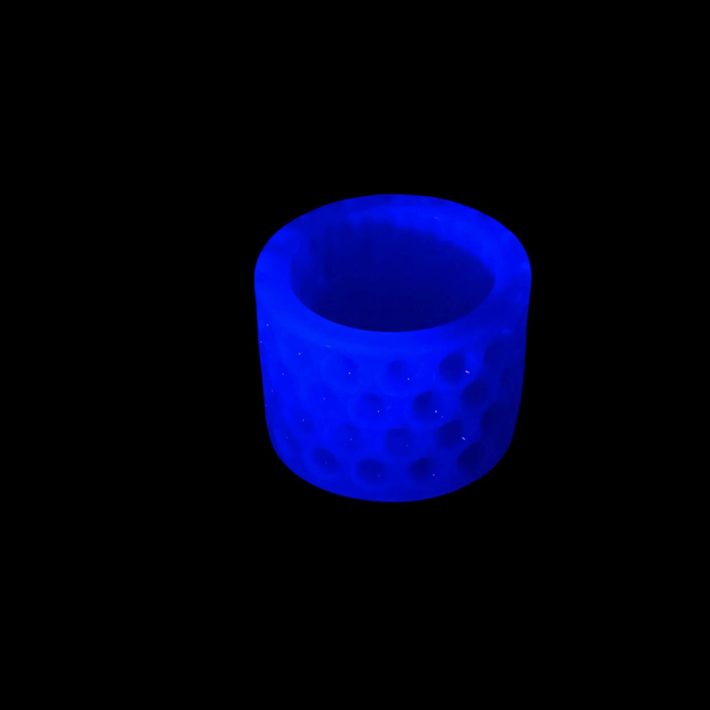 Photo showing how the decorative trinket dish fluoresces under a UV light in blue.  