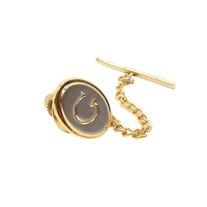 Full view of the vintage initial tie tack. Here the clutch, bar, and chain can be seen.