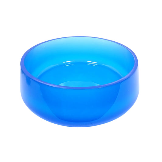 Angled side view of the large handmade neon blue decorative bowl. It is round with a slightly flared bottom. The resin is semi translucent and shiny in a neon blue color. Great to add to your UV fluorescent home decor.