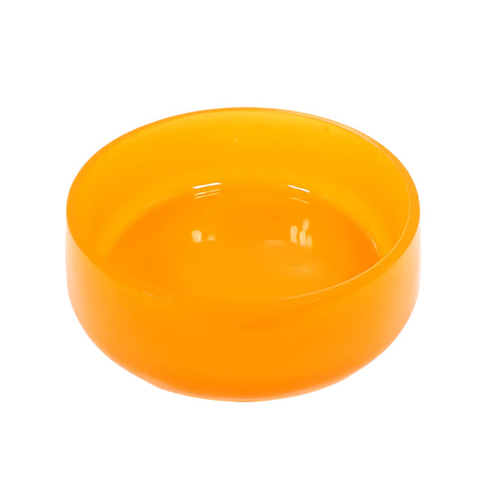 Angled view of the handmade neon orange resin decorative bowl. It is large and round with a slightly flared bottom. The resin is shiny and semi translucent in a bright neon orange color.