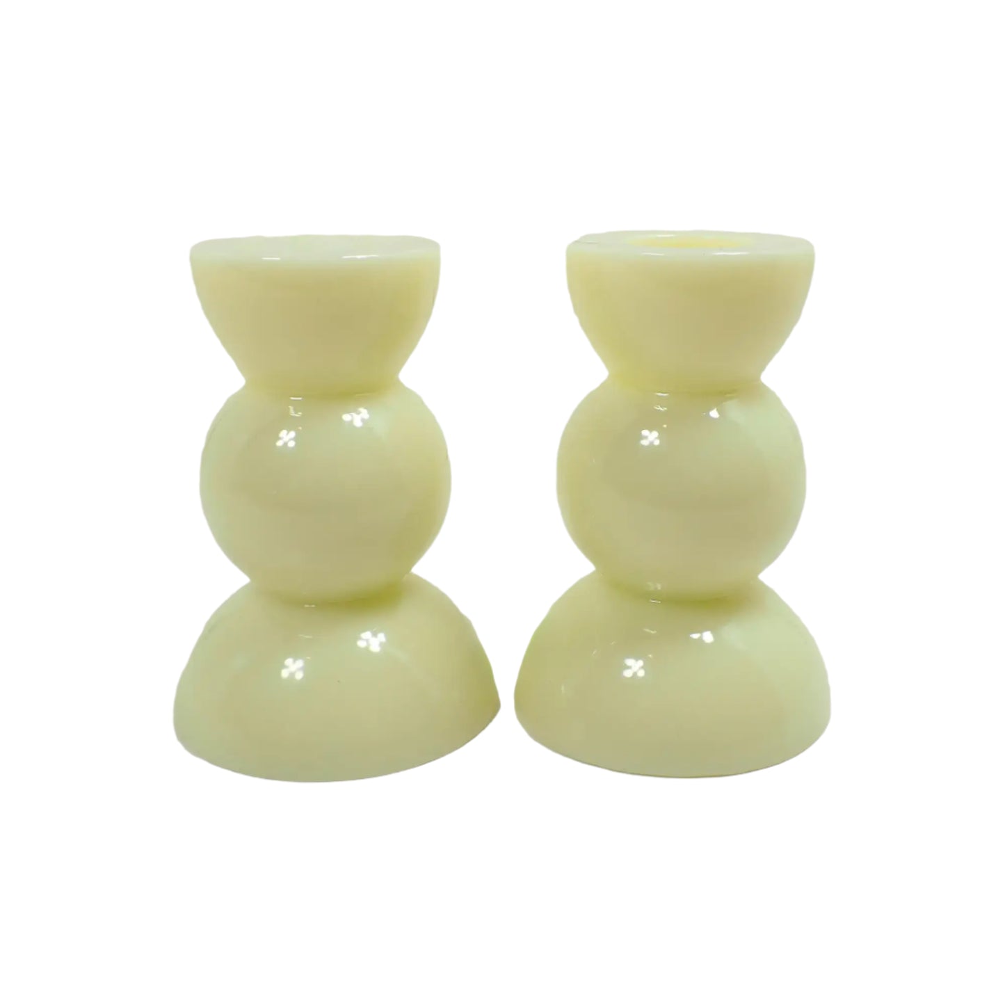 Side view of the handmade lemon cream color candle holders. There is a half sphere on the top and bottom and a round sphere shape in the middle for a geometric appearance.