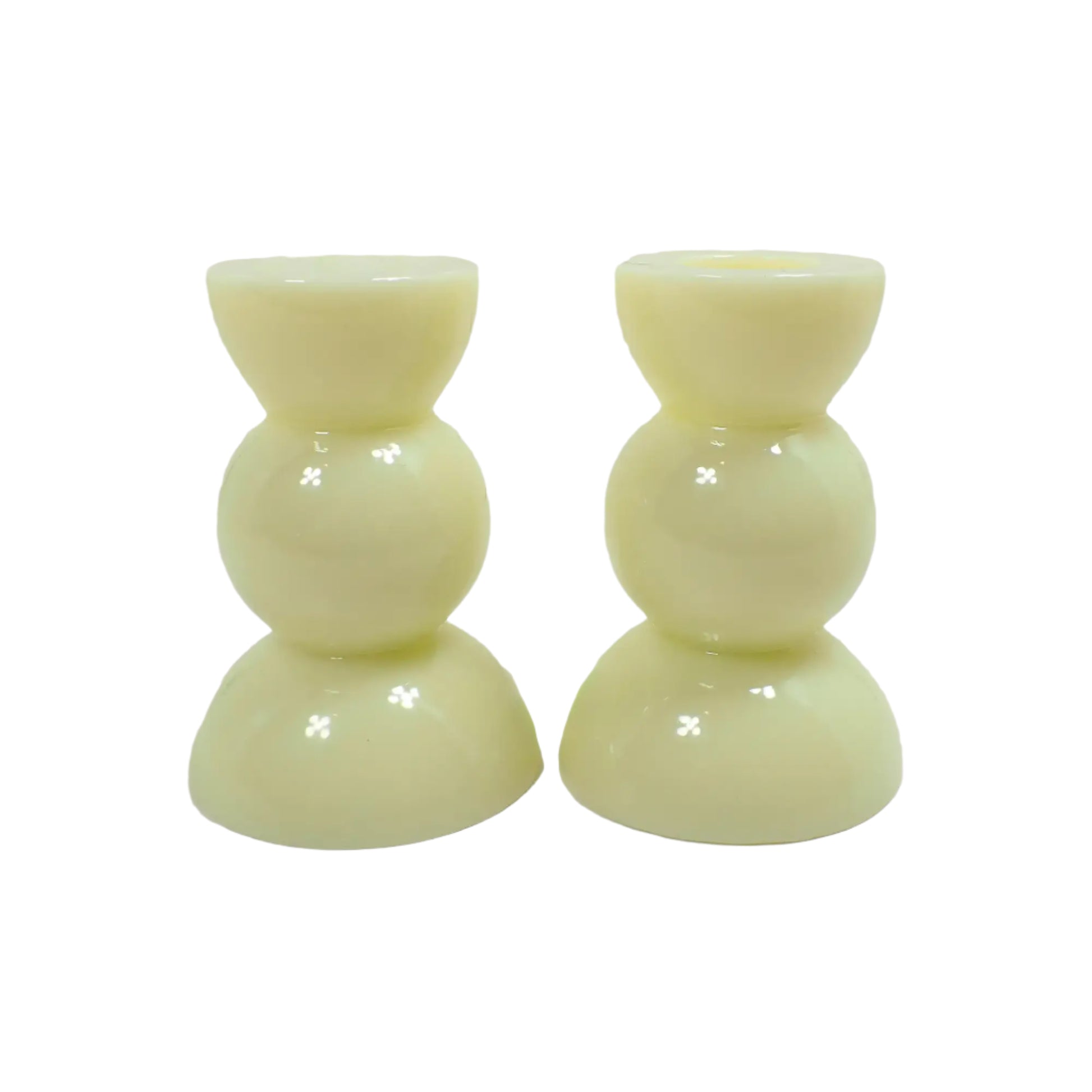 Side view of the handmade lemon cream color candle holders. There is a half sphere on the top and bottom and a round sphere shape in the middle for a geometric appearance.