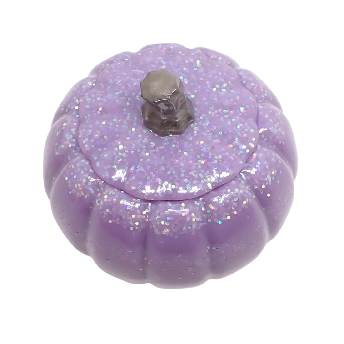 Angled view of the light purple pumpkin trinket box showing how the glitter is mostly on the lid and top part of the pumpkin.