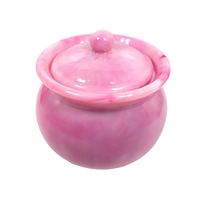 Closeup view of the handmade marbled pink resin decorative jar showing the different shades of pastel pink that are marbled together throughout the entire piece.