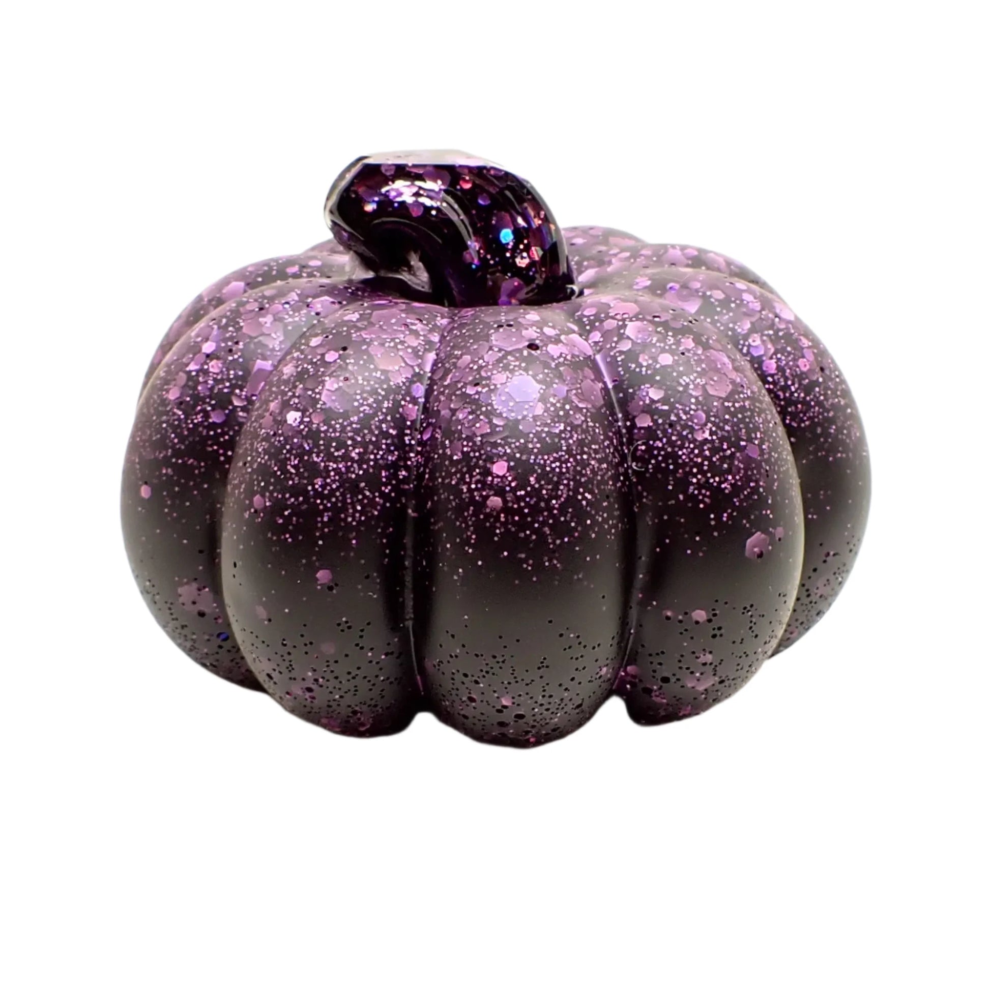 Side view of the small resin pumpkin showing where the matte black meets the matte purple glitter resin.