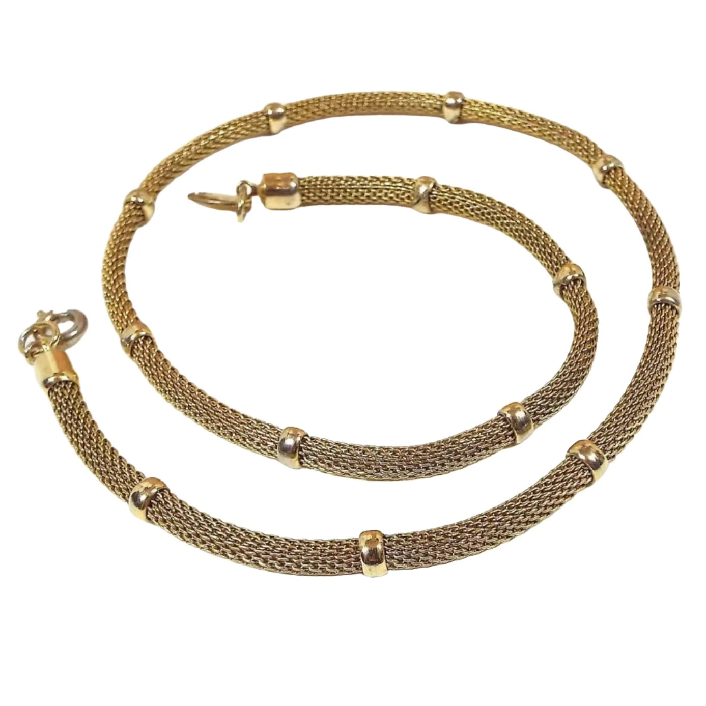 Chain is gold in color with round mesh between permanently affixed round gold color beads. It has a spring ring round type clasp. 