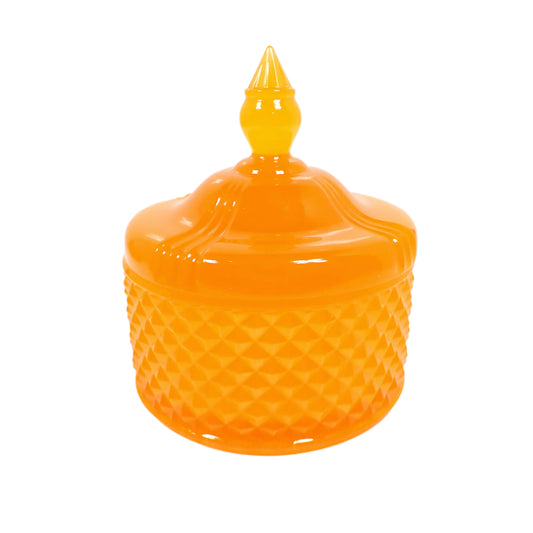 Side view of the handmade neon pink resin trinket box. It as a vintage style design with a faceted round bottom and smooth round top with a tapered knob to remove the lid with. The resin is shiny and semi translucent in a bright neon pink color. Would also be great as a candy dish for wrapped candies. 
