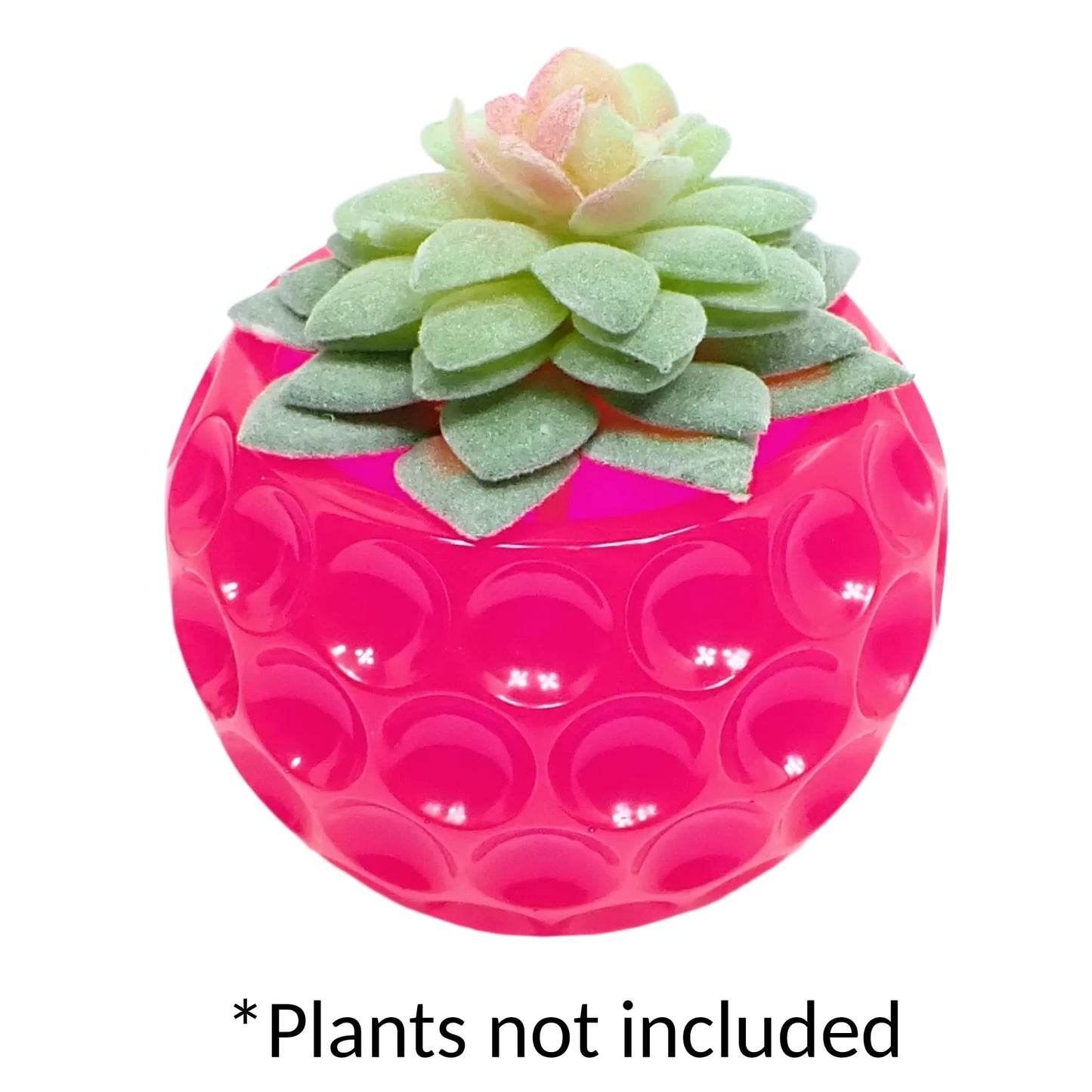 Photo showing the handmade neon pink resin decorative bowl being used as a small succulent pot with a fake succulent in it.