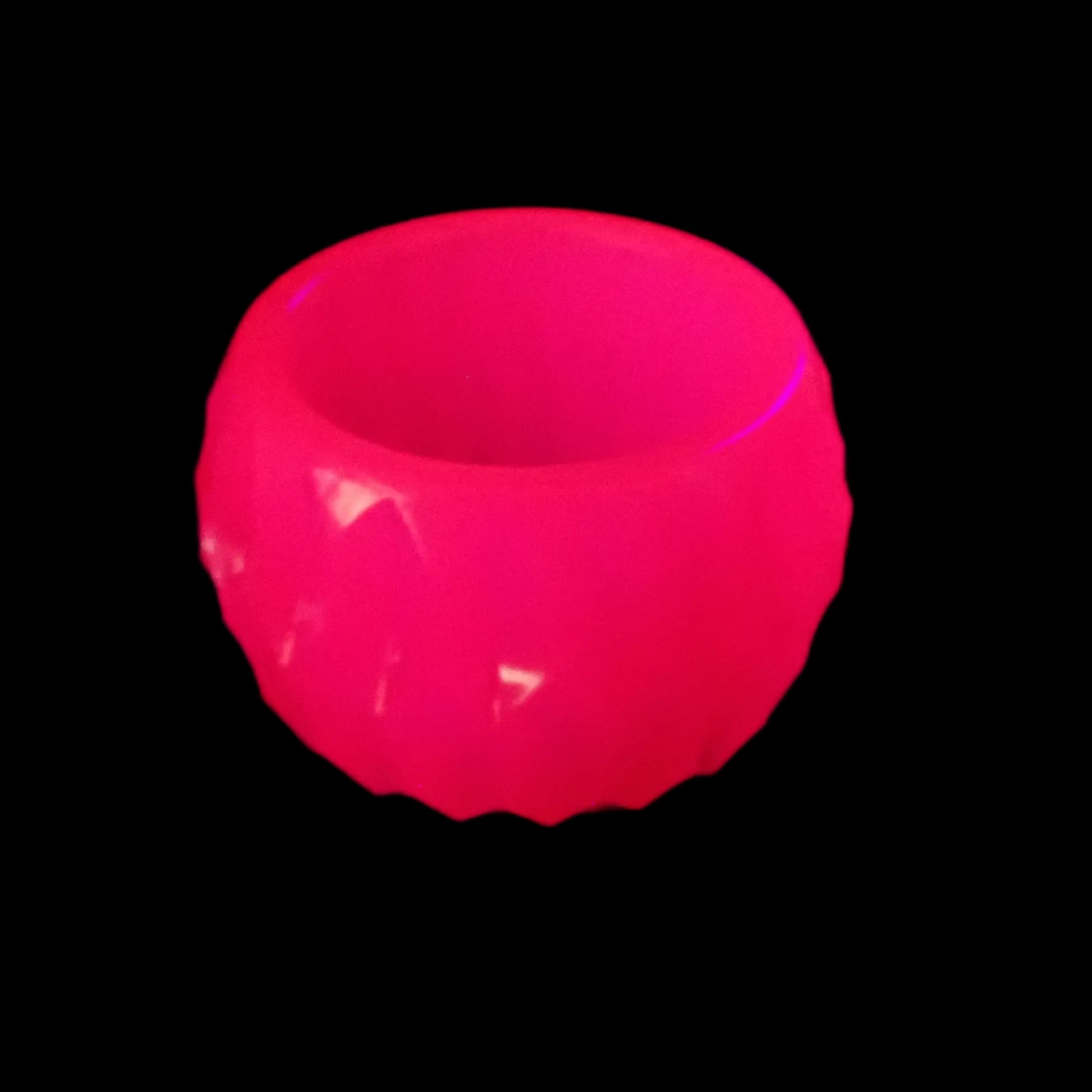 Photo under a UV light showing how the bowl fluoresces bright pink.