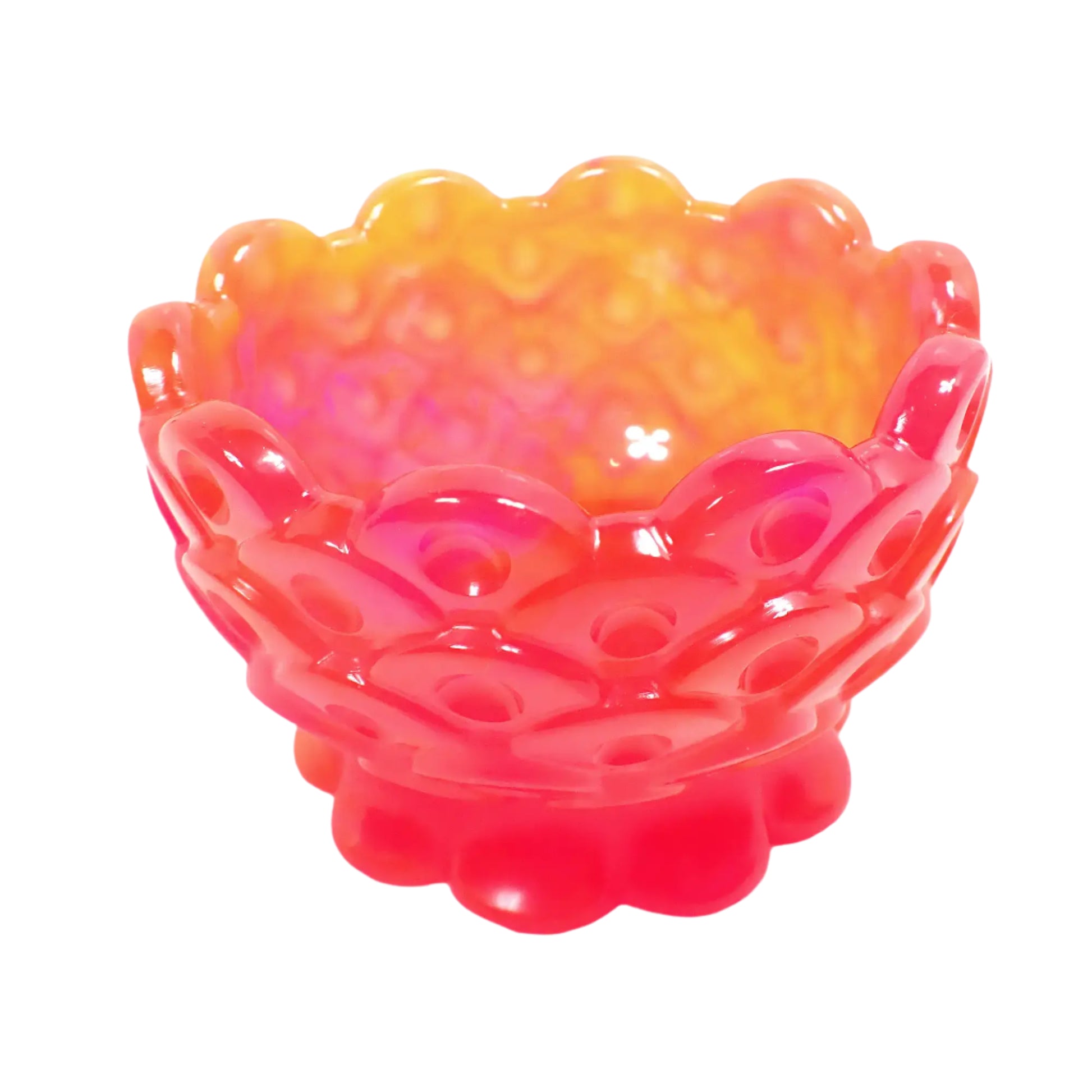 Angled view of the handmade resin decorative bowl. It has areas of neon pink and orange resin. The top and footed bottom have a scalloped edge. The rest of the bowl has a scale like design with indented dots.