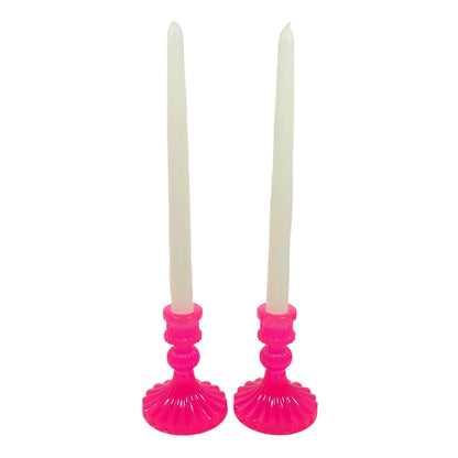 Image of the set of two handmade neon pink candle holders with off white taper display candlesticks in them to show how they would look with the candles.