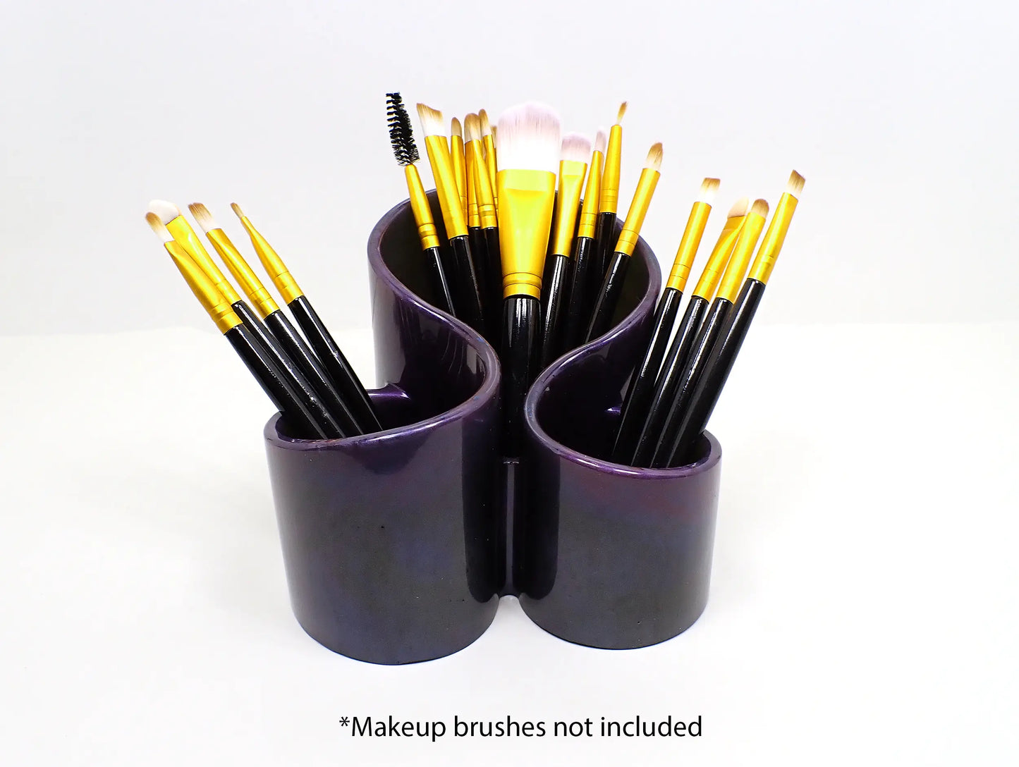 Photo showing how the handmade dark pearly resin makeup brush holder holds makeup brushes. At the bottom of the photo it says "Makeup brushes not included."