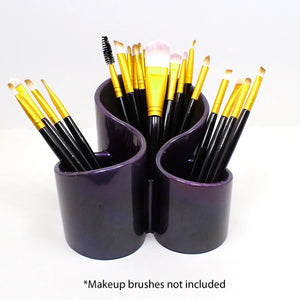 Photo showing how the handmade dark pearly resin makeup brush holder holds makeup brushes. At the bottom of the photo it says "Makeup brushes not included."