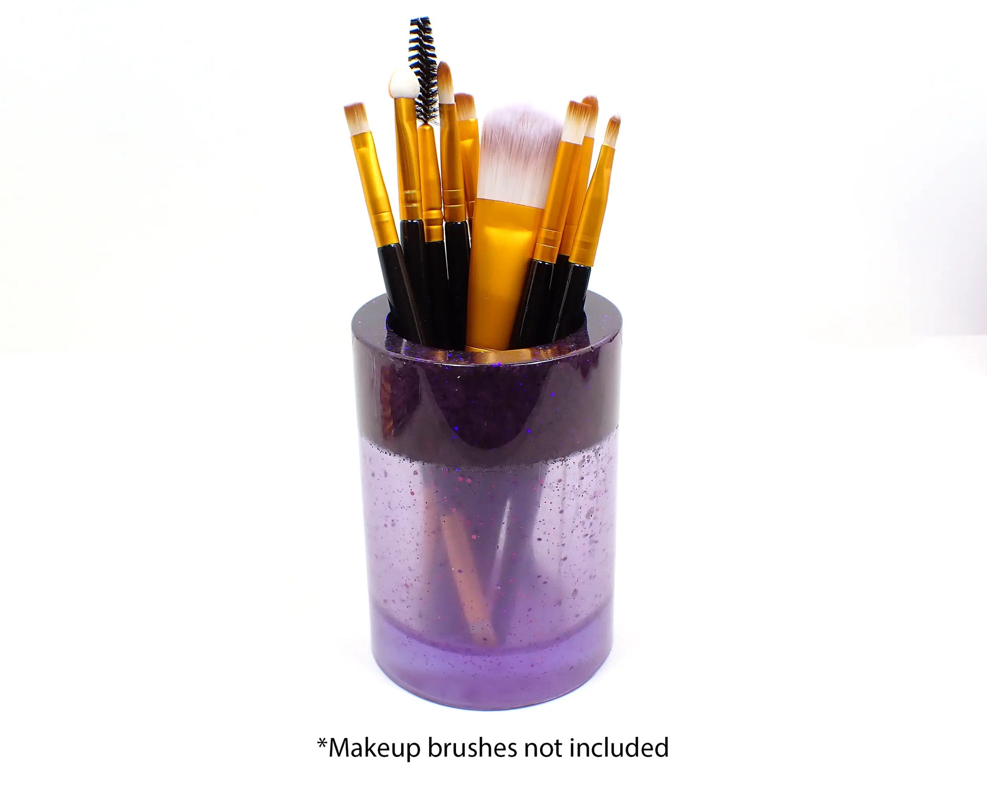 Photo showing how the holder holds makeup brushes. At the bottom it says "makeup brushes not included."