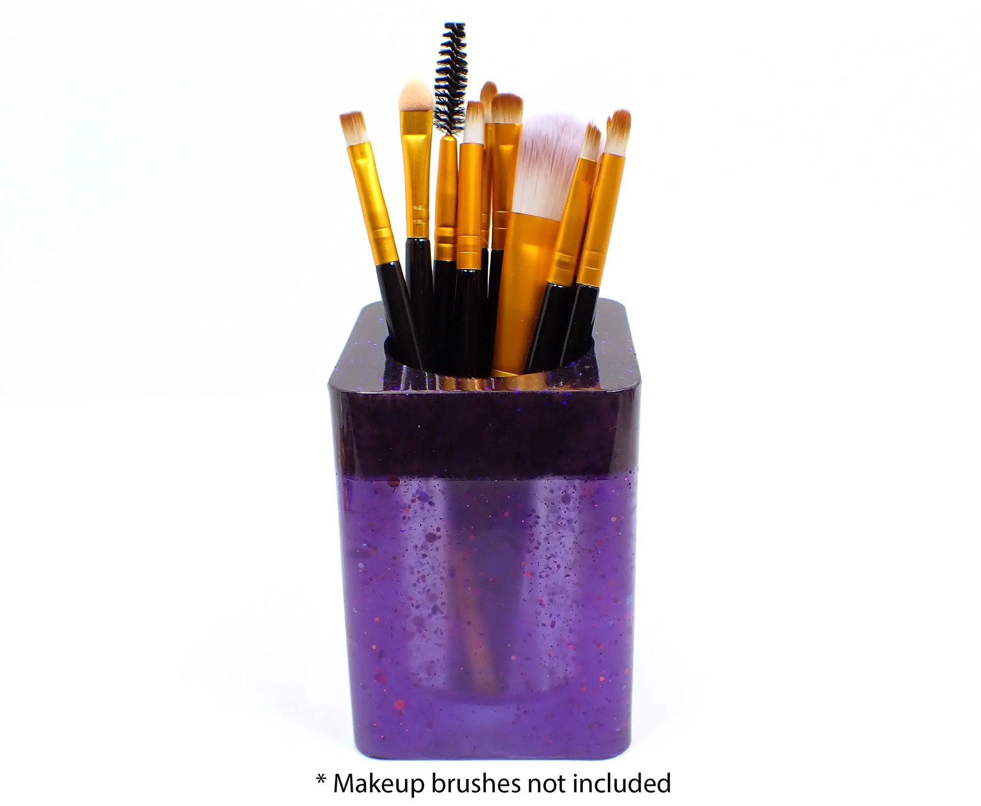 Photo showing how the holder holds makeup brushes. At the bottom it says "makeup brushes not included."