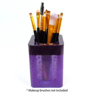 Photo showing how the holder holds makeup brushes. At the bottom it says "makeup brushes not included."