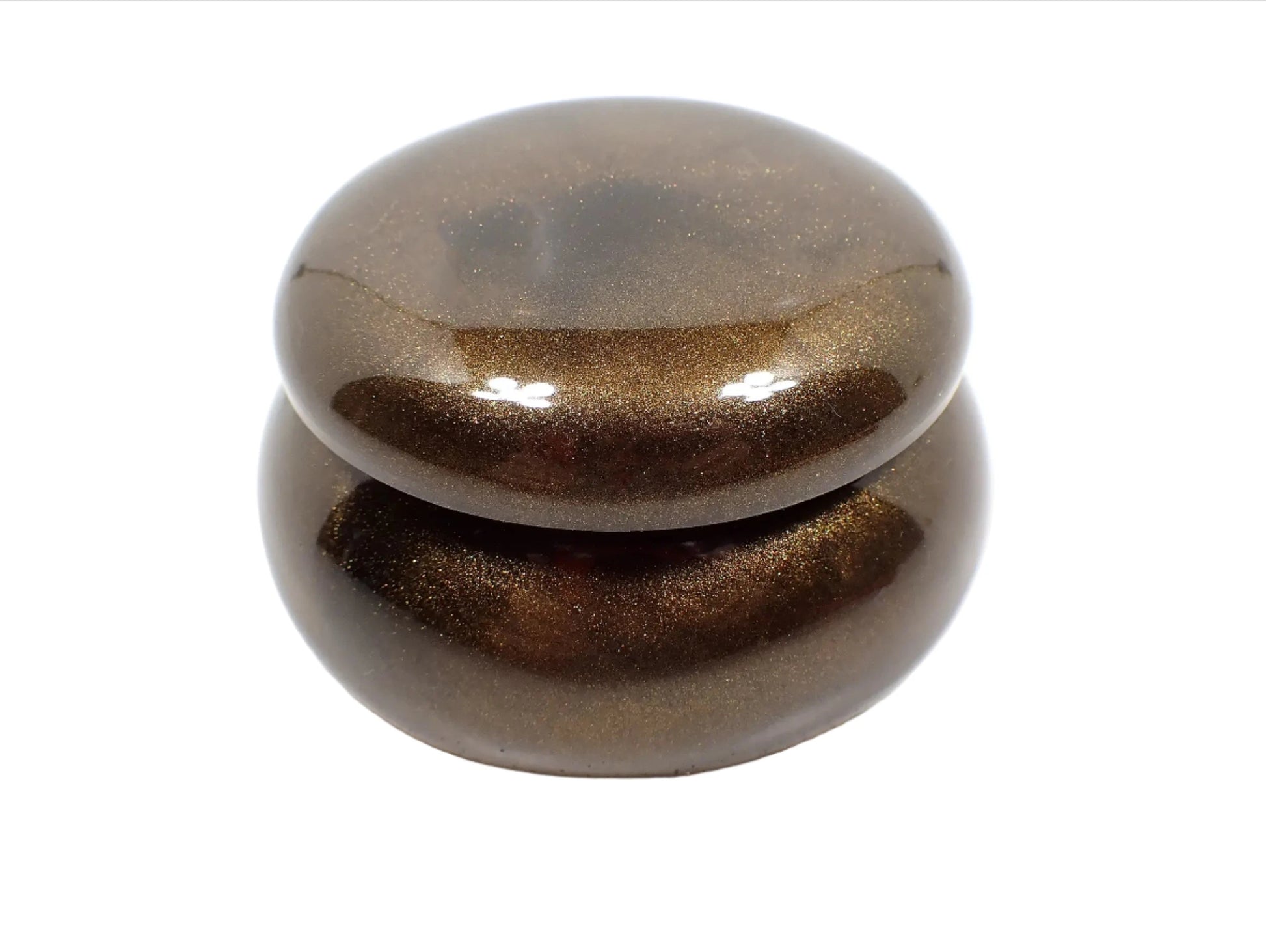 Side view of the smaller sized handmade resin trinket box. It has a rounded wide jar like shape with a round lid. The resin is pearly chocolate brown in color.