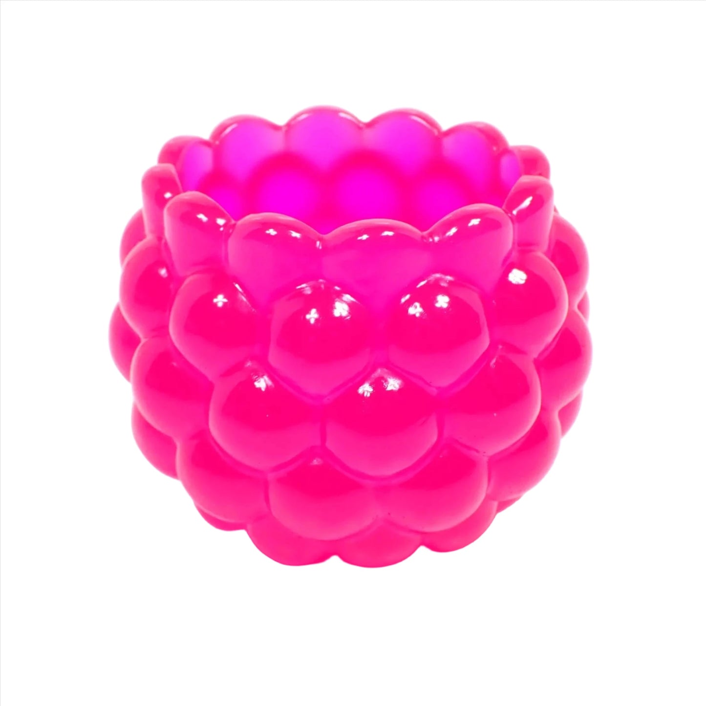 Side view of the handmade resin decorative bowl. The resin is bright neon pink in color. It has a rounded shape with a bumpy round ball textured on the outside. The top tapers slightly and has a scalloped edge.