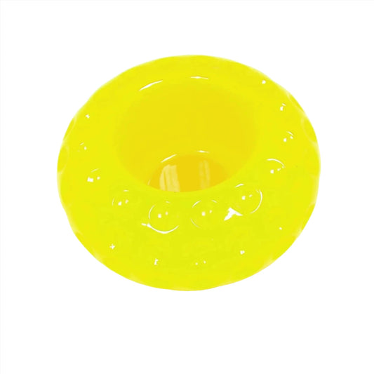 Angled view of the handmade neon tea light candle holder. It is a round saucer like shape with indented dots all the way around it. There is an opening at the top for the candle. The resin is neon yellow in color.