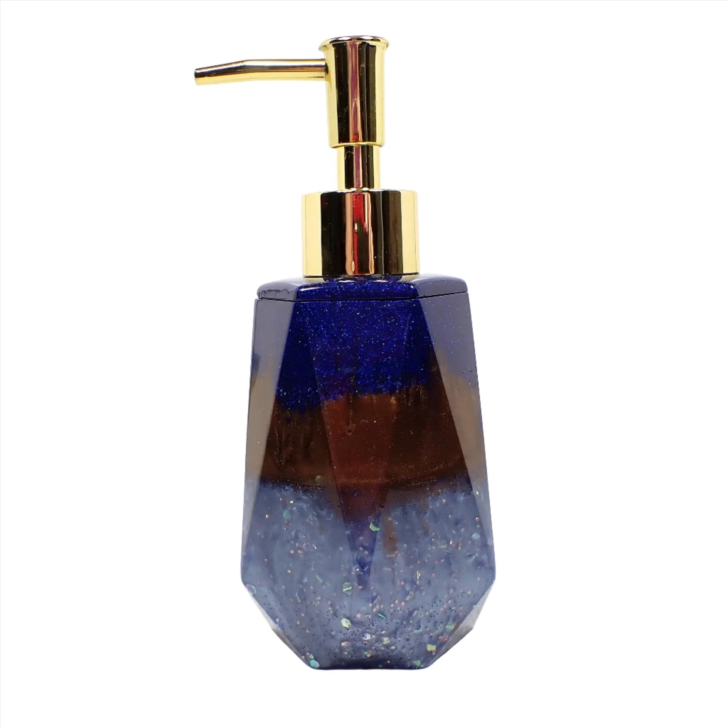 Side view of the handmade resin soap dispenser. In this photo it has a gold tone color pump on it. The top part of the dispenser has pearly dark blue resin with tiny flecks of blue glitter. The middle of the dispenser has pearly brown resin and the bottom has pearly light blue resin with chunky iridescent glitter. It has a faceted shape that is narrower at the top and flared at the bottom.