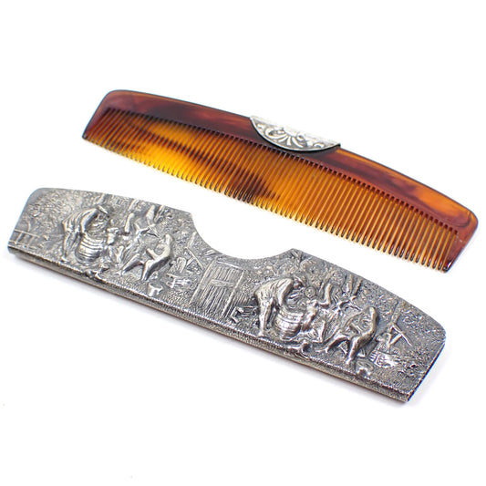 Angled view of the Mid Century vintage Denmark comb and case. The case and top part of the comb is gray in color. The rest of the comb has a tortoise shell color design on the plastic. The case has a repousse design of people doing various things.