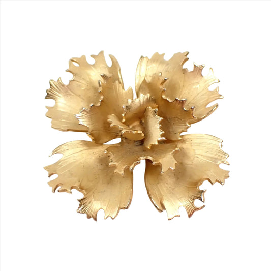 Top view of the retro vintage Giovanni flower brooch pin. The metal is matte gold tone in color. The flower has petals with jagged like edges that are curled a bit outward. 