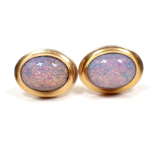 Front view of the Mid Century vintage 1940's Correct Quality cufflinks. They are oval shaped with gold tone color metal. There are faux opal glass cabs on the front with mostly hues of pink, red, yellow, and orange.