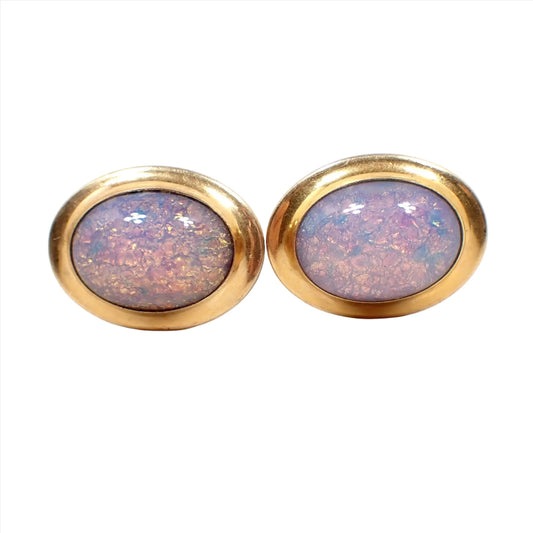 Front view of the Mid Century vintage 1940's Correct Quality cufflinks. They are oval shaped with gold tone color metal. There are faux opal glass cabs on the front with mostly hues of pink, red, yellow, and orange.