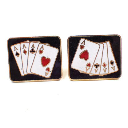 Front view of the retro vintage playing card cufflinks. They are rectangular in shape with gold tone color metal. The fronts have black enamel with white, black, and red playing card design showing a 4 of a kind Poker hand with Aces. 