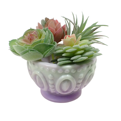 Photo of the handmade resin footed bowl showing how it would look with small succulent plants in it.