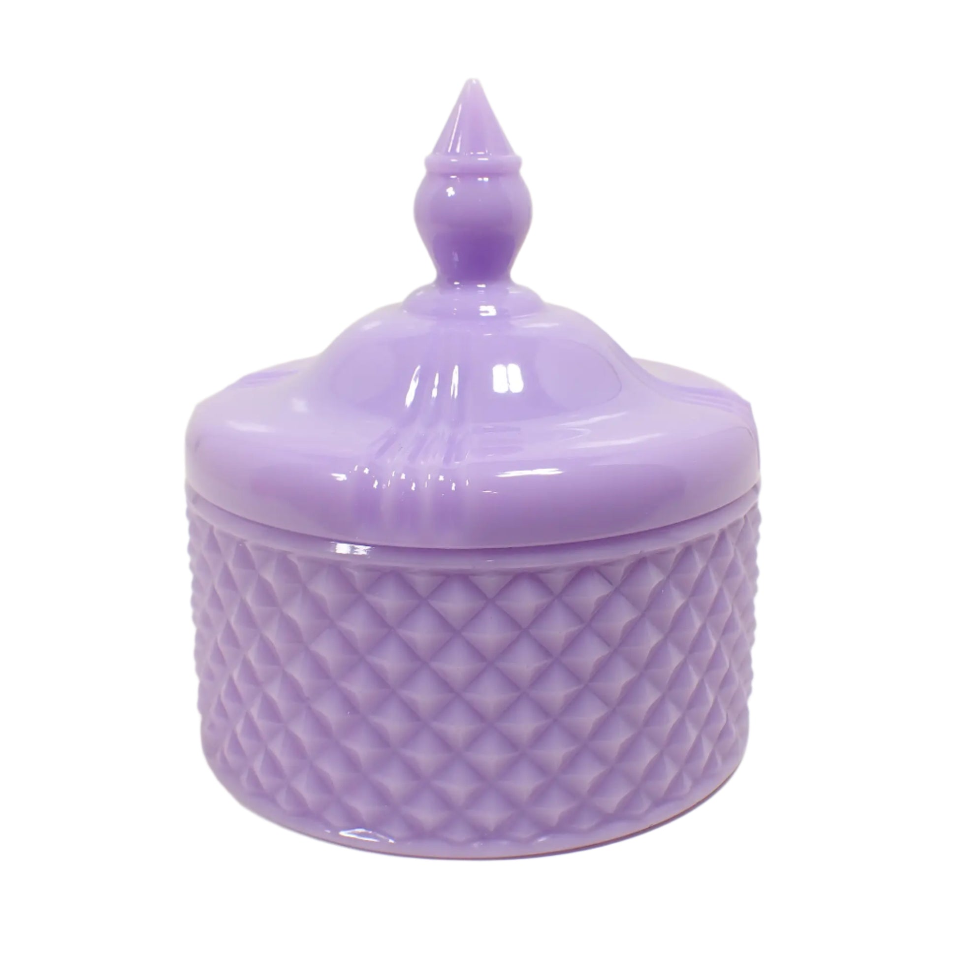 Side view of the pastel purple trinket box. It has a round vintage style appearance with a tapered knob on top to remove the lid. The bottom has a textured diamond shape pattern all the way around.