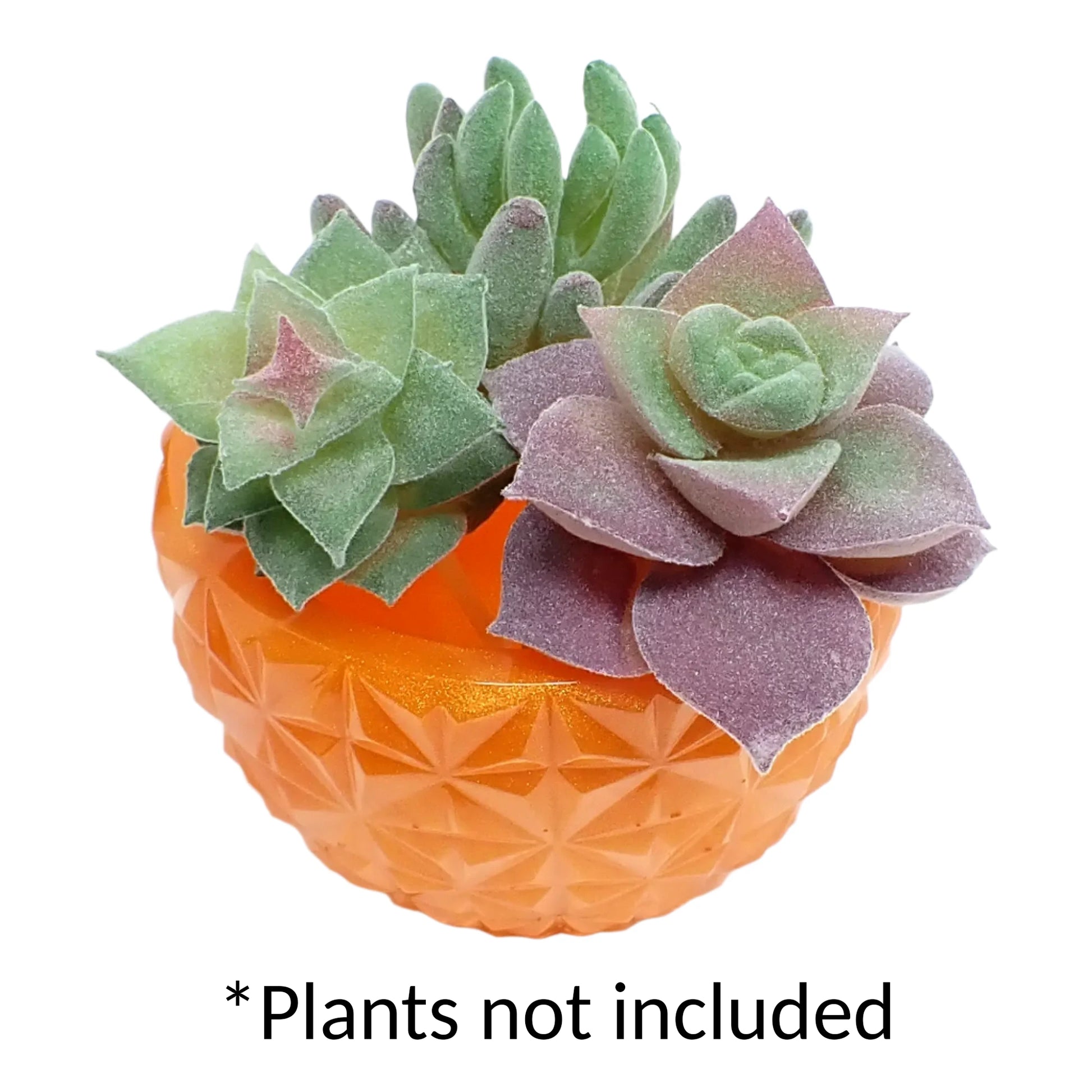 Photo showing the handmade pearly orange resin faceted bowl holding fake succulent plants. There is wording at the bottom of the picture that says "plants not included."